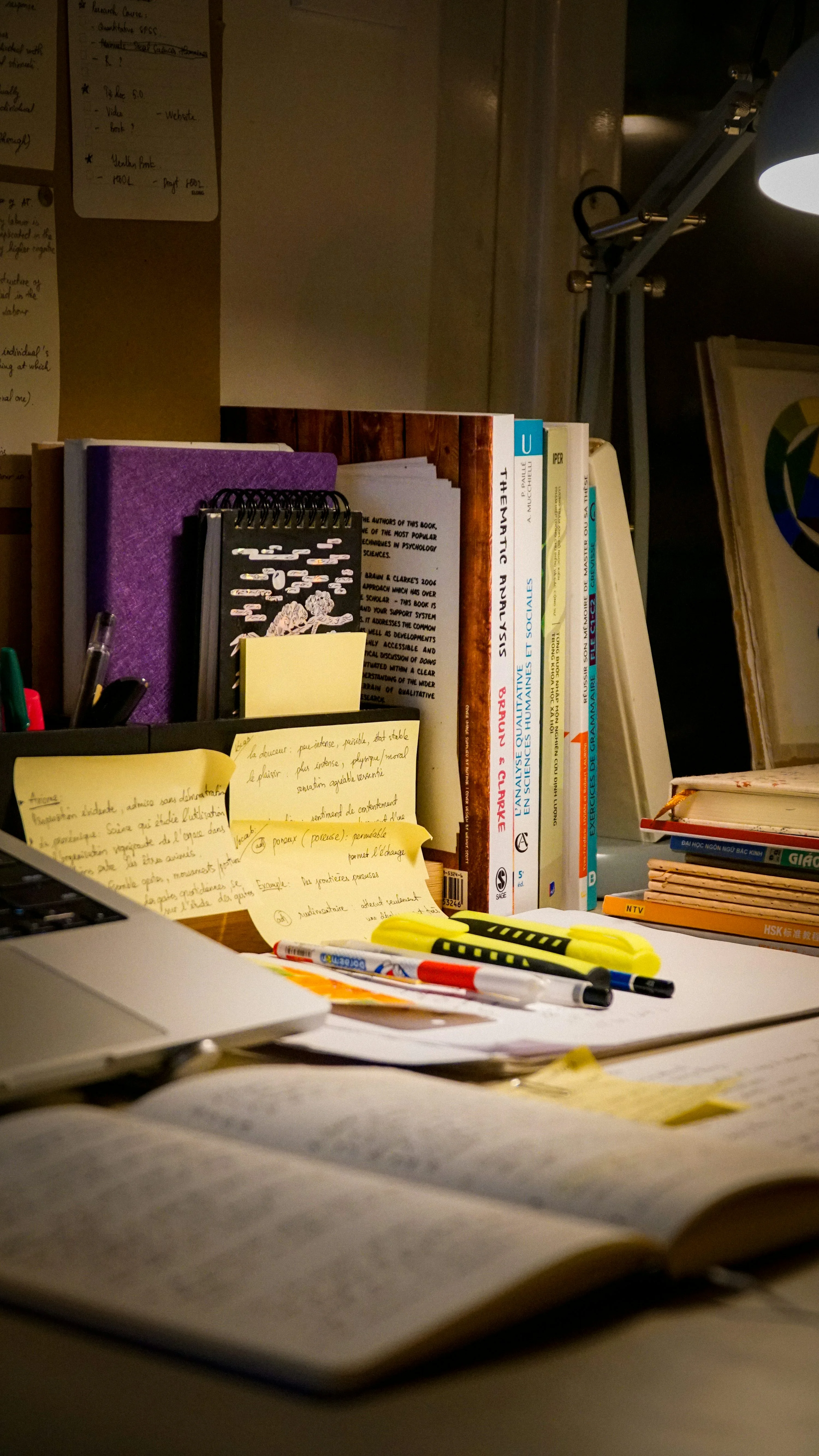 Desk with open book, laptop, and study materials